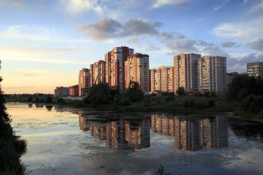 Gün batımında nehir kıyısında yeni apartmanlar. Balashikha, Rusya Federasyonu.