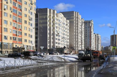 BALASHIKHA, RUSSIA - MARCH 19, 2021. Flooded street in a residential area in the spring. Snow melting. City of Balashikha, Moscow region, Russia.
