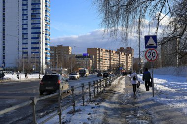 BALASHIKHA, Rusya- 19 Mart 2021. Baharda güneşli bir günde yerleşim yeri. Erimiş kar ve buzla kaplı kirli kaldırım. Balashikha şehri, Moskova bölgesi, Rusya.