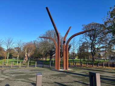 Hull, East Yorkshire, UK, November 13th Anlaby Rd, Public Art Sculpture in Park With Bending Steel Arms Under Clear Blue Sky