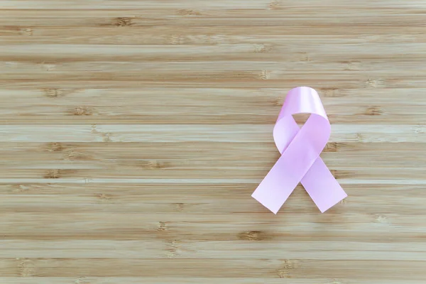 Pink ribbon awareness symbol : Symbolic logo icon concept raising awareness campaign on cancer day.