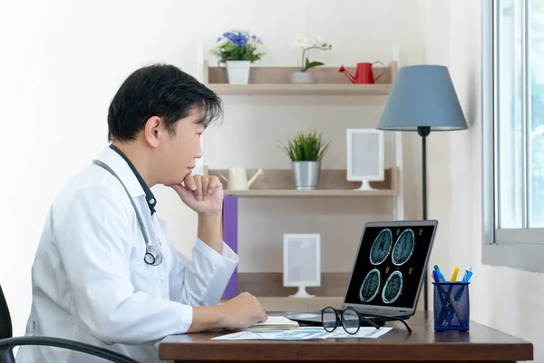 Doctor checking Xray results on laptop. Doctor using digital smart device to read Xray results online. Modern technology