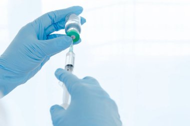 Aşılar virüse karşı savaşıyor, doktor ya da bilim adamı laboratuarda elinde sıvı aşılarla bir şırınga tutuyor. Kavram: hastalıklar, tıbbi bakım. 