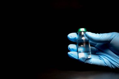 Siyah arka planda potansiyel deneme aşaması konsepti. Şişeleri steril şırıngayla kapatın. Araştırma ve Geliştirme, Aşılama Konsepti.