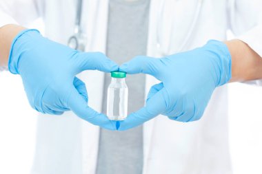 Aşılar virüse karşı savaşıyor, doktor ya da bilim adamı laboratuarda elinde sıvı aşılarla bir şırınga tutuyor. Kavram: hastalıklar, tıbbi bakım.