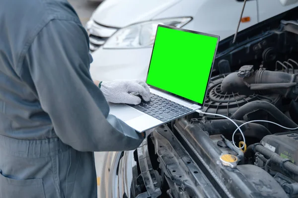 Wykwalifikowany Mechanik Korzystający Laptopa Sprawdzania Informacji Podczas Pracy Silnika Samochodowego — Zdjęcie stockowe