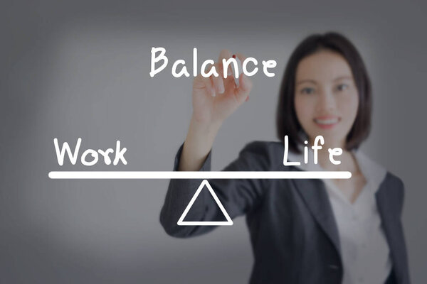 businesswoman balance his work and life on board tip. Business concept.