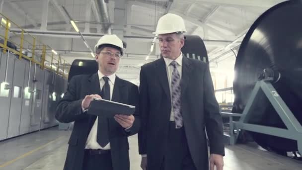 Two businessmen walking through factory — Stock Video