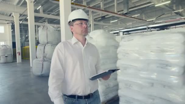 Ingeniero caminando por el almacén parte de la fábrica — Vídeos de Stock