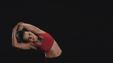 Genç kadın esneme egzersizleri yapıyor. 