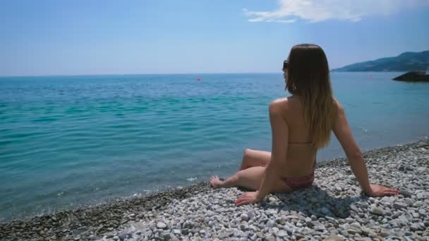 Mujer atractiva joven relajándose en la playa. Ella relajada y feliz . — Vídeos de Stock