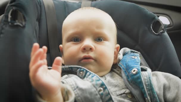 Seguridad en el coche para los niños. Niño sentado en un asiento de coche especial — Vídeos de Stock