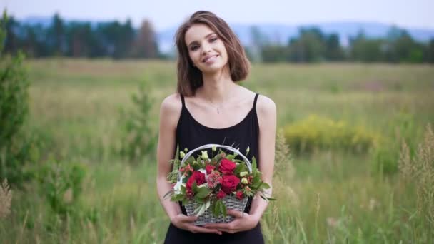 Portret pięknej dziewczyny z koszem kwiatów w dłoniach. — Wideo stockowe