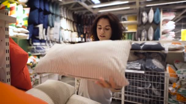 Mulher bonita, jovem escolher um travesseiro na loja — Vídeo de Stock