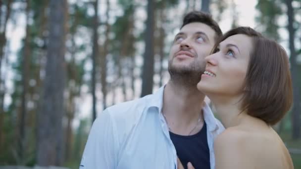 Portret van twee aantrekkelijke jonge mensen, jongens en meisjes in het dennenbos. — Stockvideo