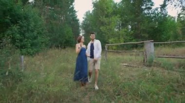 Young man in shirt and sh rtah leads for a his beloved wife.