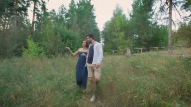 Young man in shirt and sh rtah leads for a his beloved wife.