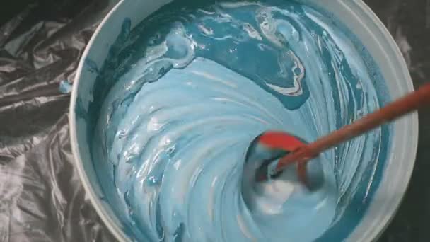 The process of mixing white paint with a color tinge in the bucket drill with a special nozzle prevents paint. — Stock Video