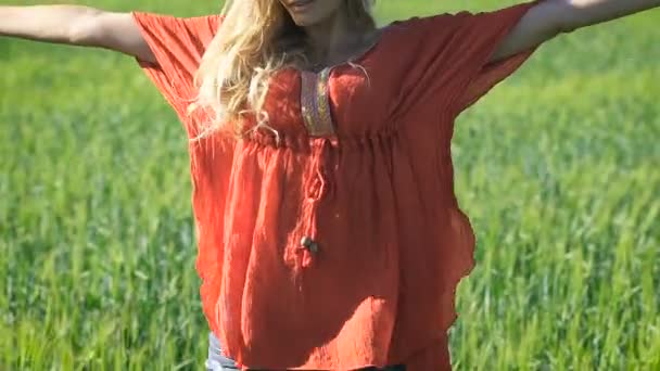 Close-up retrato de uma bela loira jovem mulher romântica com o corpo perfeito em uma camisa vermelha no campo verde. Respiração — Vídeo de Stock