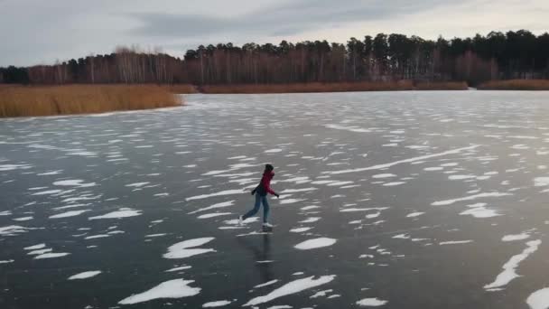 Vue aérienne. Activités hivernales amusantes et sur glace. Le réservoir est recouvert de glace et maintenant vous pouvez patiner dessus. — Video