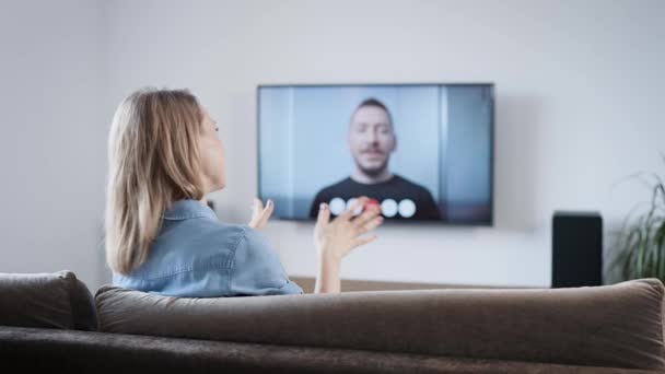 Uma mulher está falando em casa via link de vídeo. Vídeo chat na TV com o seu namorado. — Vídeo de Stock