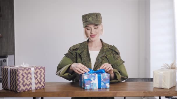 Dziewczyna w khaki ubrania lubi prezenty. Mundur wojskowy na blondynce — Wideo stockowe