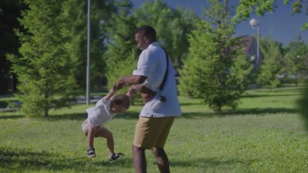 Afro-Amerikaanse vader met zijn zoon in het park. Vader en zoon veel plezier.. — Stockvideo