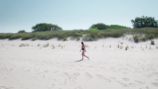 Flygfoto. Vacker kvinna i baddräkt på stranden av det baltiska havet. — Stockvideo
