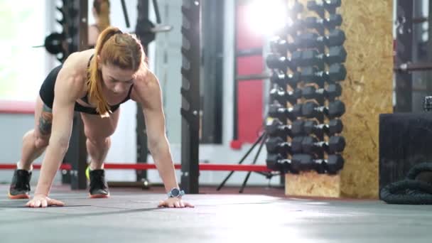 Дівчина виконує штовхання з підлоги в спортзалі — стокове відео