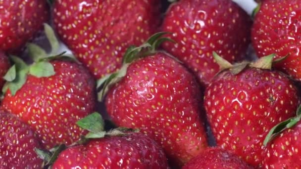 Ζουμερές ώριμες φράουλες περιστρέφονται σε ένα πιάτο. Ιστορικό διαφήμισης, φράουλες, — Αρχείο Βίντεο