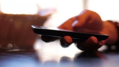 Kafede bir smartphone kullanarak eller