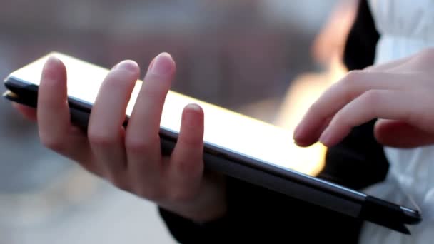 Close up of female hands using tablet computer on the balcony — Stock Video