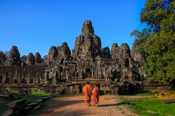 The monks in the ancient stone faces of Bayon temple, Cambodia