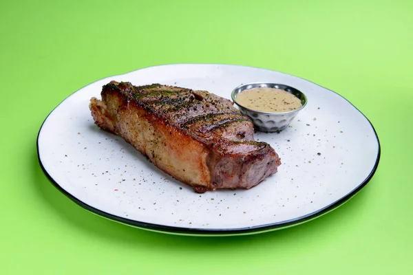 Bife Delicioso Com Molho Servido Prato Branco Sobre Fundo Verde — Fotografia de Stock