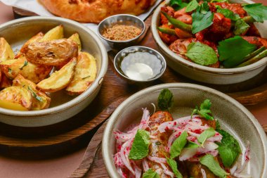 Assortment of georgian food, flat lay. Top view on traditional georgian cuisine, baked potatoes, grilled sausages, baked vegetables on the table. Georgian concept.