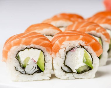 Maki Suşi, füme somon ve krem peynirden yapılmış rulo. Geleneksel Japon mutfağı kavramı, beyaz arka planda. Geleneksel tarif.