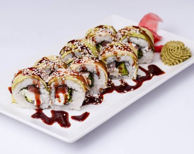 Beyaz arka planda beyaz bir tabakta servis edilen suşi küçük seti. Geleneksel Asya Japon mutfağı konsepti, kapatın..