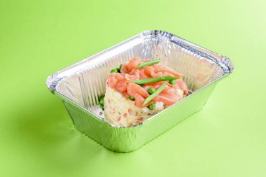 Folyo teslimat kutusunda somonlu salata Olivier, konsepti çıkar. Dünya çapında salgın nedeniyle yiyecek sevkiyatı.