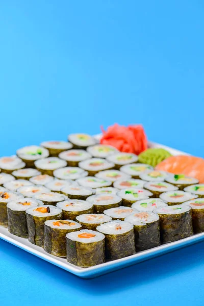 Sushi Velký Set Sloužil Bílém Talíři Nad Modrým Pozadím Tradiční — Stock fotografie