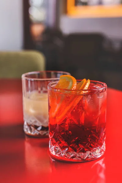 バーやレストランで果物やベリーとカクテル 背景がぼやけている テーブルの上でユニークなグラスで提供されるアルコール飲料 飲み会 — ストック写真