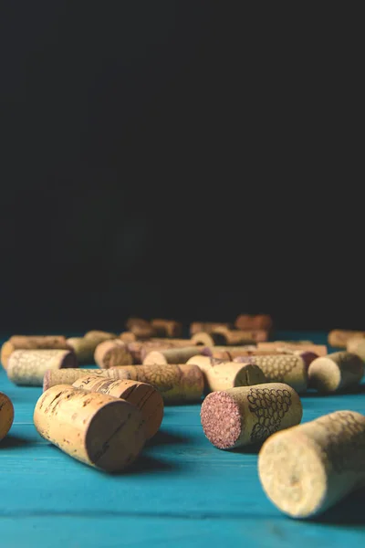 Collection set of wine corks over pastel blue rustic wooden background. Art concept, creative idea. Spring table