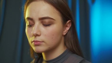 The young woman puts on beautiful earrings. Close up of beautiful smiling confident young woman. Getting ready in the morning.