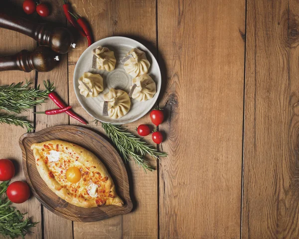 Georgian cuisine foodset from khachapuri and khinkali flat lasy. Traditional Georgian cuisine concept. Copy space web design banner. Over rustic wooden table with spices and vegetables.