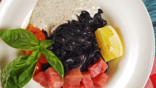 Black Cuttlefish Ink Pasta Salmon Fish Lemon Basil White Plate — Stock Video
