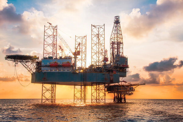 Offshore Jack Up Rig in The Middle of The Sea at Sunset Time