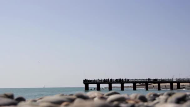 Fishermen go Fishing on the Pier on Yhe Sea, in the Background Flying Airplane — Stock Video