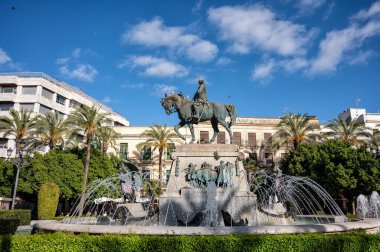 Jerez de la Frontera, Cadiz, Spain; 06-11-2025: Equestrian statue monument to Miguel Primo de Rivera in Jerez, Spain, with fountain sprays under blue sky