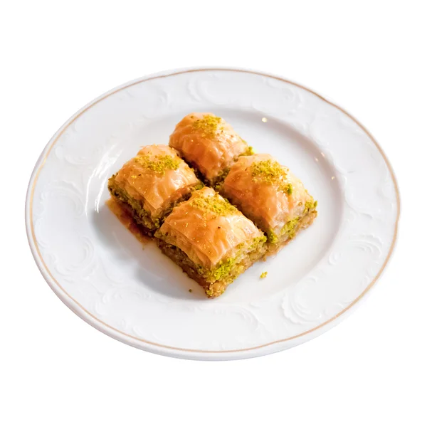 Delicioso postre turco Baklava sobre un fondo blanco — Foto de Stock