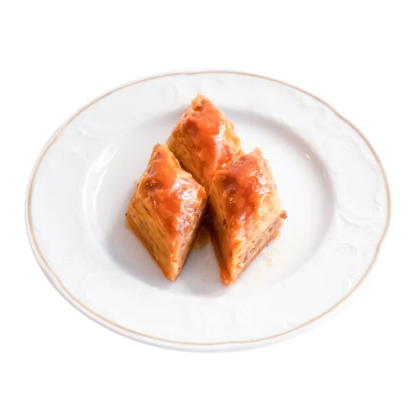 Delicioso postre turco Baklava sobre un fondo blanco — Foto de Stock