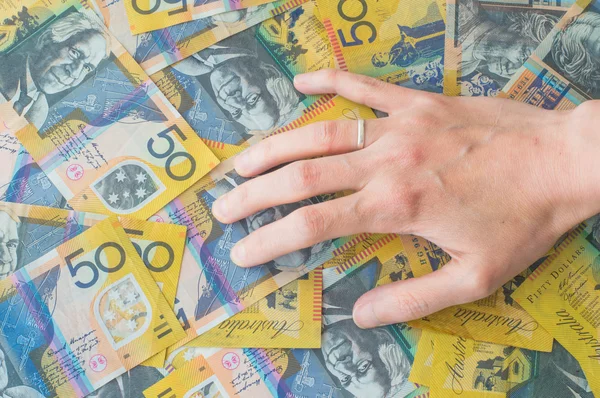 Woman\'s hand on Australian Dollar banknote